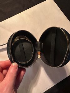 inside of case with mirror (left side) and strap on right side to hold small items