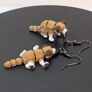 A side view of the dog earrings, showing how the one standing is more of a sit with the way its back legs are modeled.