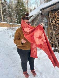 Me putting on the Red Madder Spiderweb scarf with the tail flying in the breeze