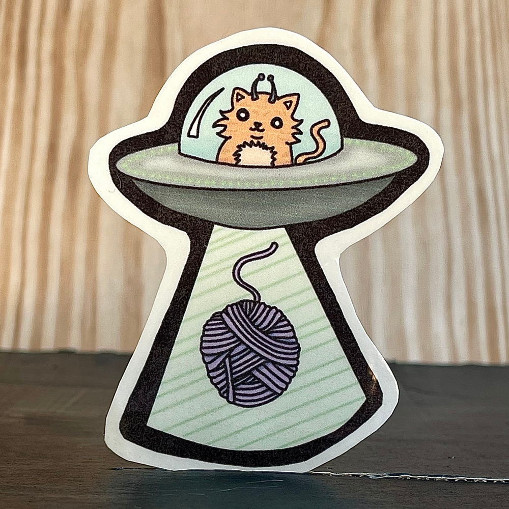Orange Cat in a Flying Saucer Sticker