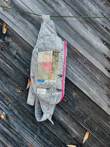 Offset rectangular patchwork insert fanny pack hanging against a wall