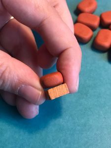 A thickness comparison of a standard token vs my homemade one
