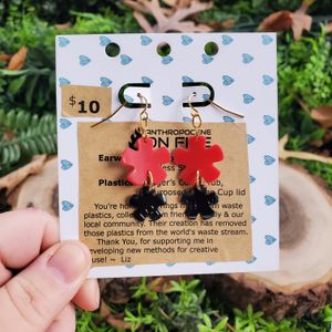 Larger Red Asterisk on Top, Smaller Black Asterisk on Bottom