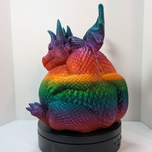 A side view of the rainbow colored 3D printed container. It's still very wide.