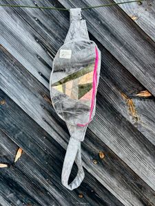 Triangular patchwork insert fanny pack hanging against a wall