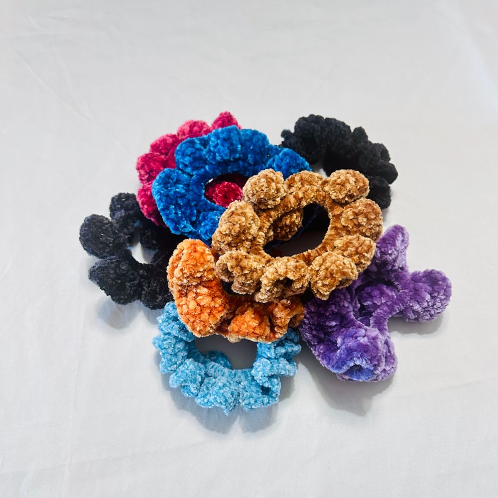 small hand-crocheted plush scrunchies of various colors
