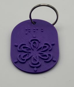 Purple keychain with raised NFB logo and braille "NFB" above it
