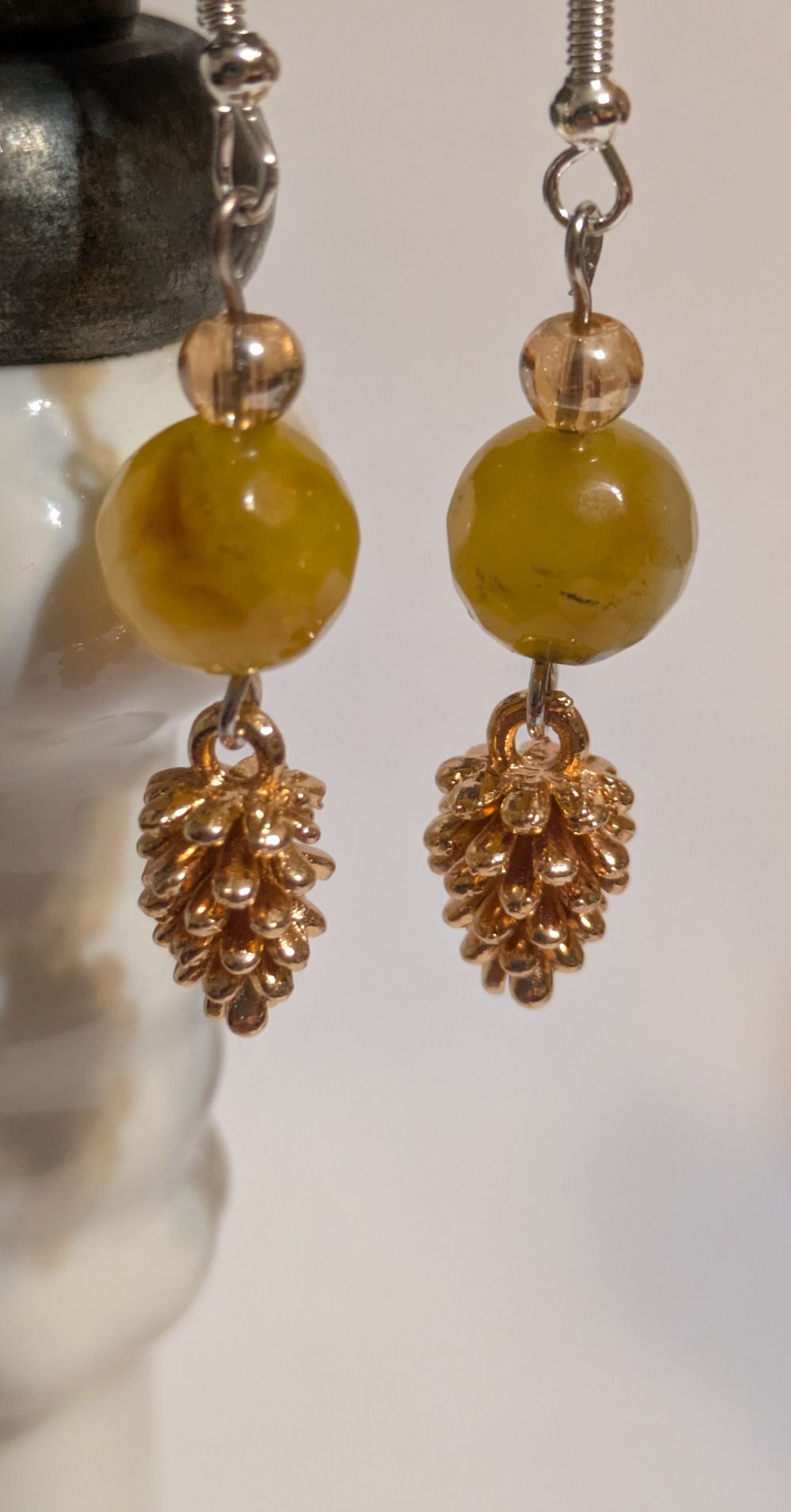 Copper pinecone dangling earrings; amber glass bead accents