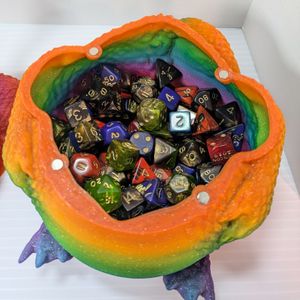 The inside of the dragon container, filled about halfway with a lot of colorful dice.