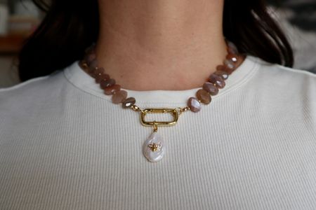 The Lucent Necklace worn with the gold carabiner clasp and removable pearl & bee charm in front.