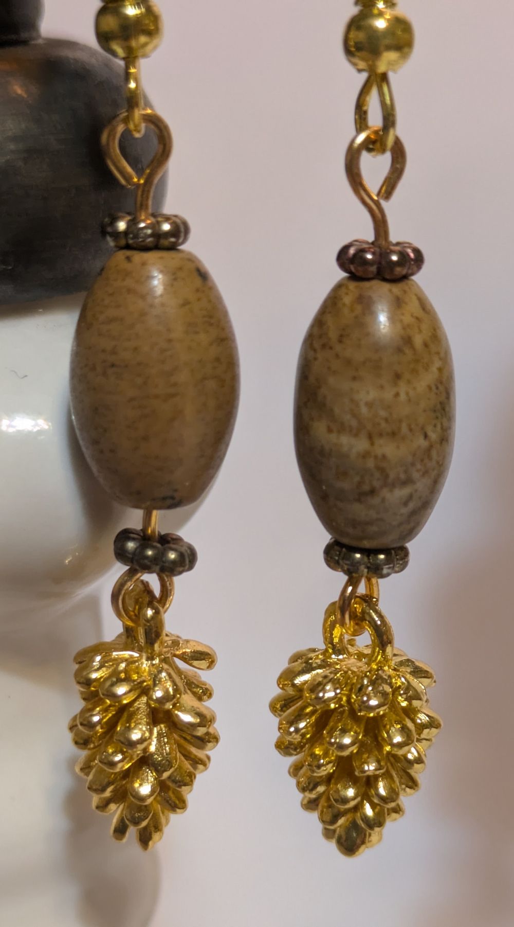 Golden pinecone dangling earrings; stone bead accents