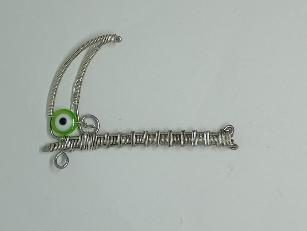 Green evil eye scythe pendant 