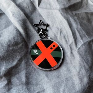 Keychain with design of Bakugou’s hero suit with gunmetal gray star clasp on gray fabric