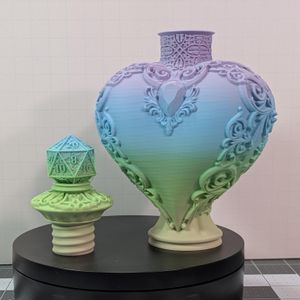 A heart shaped 3D printed bottle, made out of a pastel filament that goes from a light yellow, to green, to blue, to purple. The screw off cap has a D20 on top, and there is scroll work around the bottle.