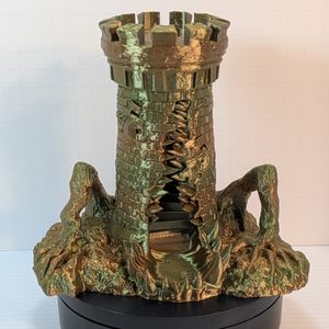 A 3D printed tower, printed in a shiny earth-tone gradient. The print is a dice tower, shaped like a stone tower, but it's a mimic. A toothy maw goes up the side, two windows look like eyes, and branches on either side look like arms pushing it up.
