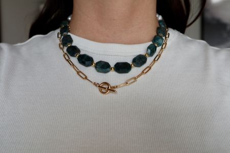 The Azurea Necklace worn with the apatite in front, layered with a gold paperclip necklace.