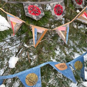 Different buntings hanging in a Fir tree
