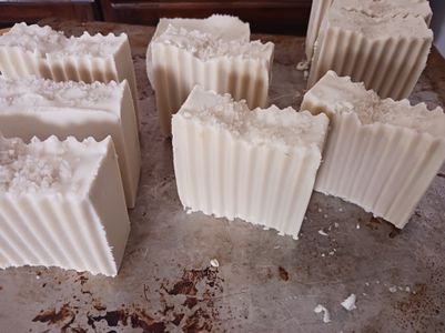 All natural soap made with Irish Sea Moss and Celtic Sea Salt. No added fragrance or color. Image shows white soap with a wavy cut with salt crystals on top.