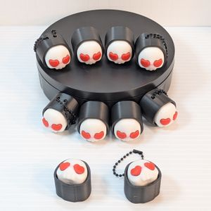A display of ten Heart Skull clickers, half with chains, half without. They are showing different angles of the clicker.