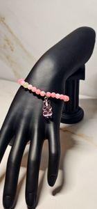 Pink and white beads paired with a gummy bear that compliments the bracelet.