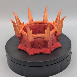 A side shot of the cup, showing it go from reddish to orangish to yellowish as you look from the bottom to the tops of the spikes.