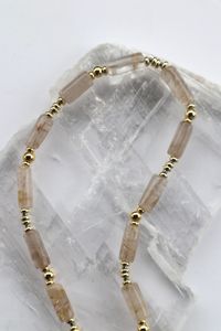 The rutilated quartz cylinder beads on the Rutila Necklace, each bead their own unique piece