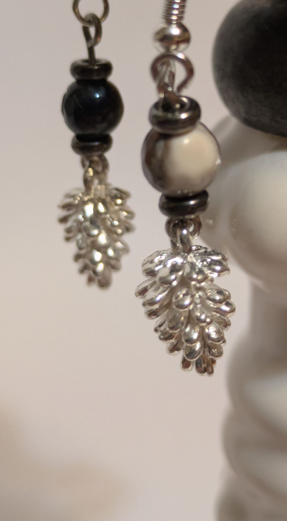 Silver pinecone dangling earrings; black/gray glass bead accents