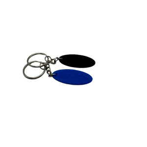 Two oval keychains, each with a word in braille and a silver keyring and short chain