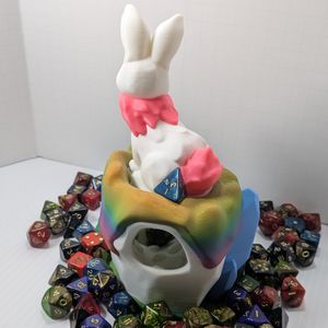 The back side of the dice tower, showing the large entrance for the dice to go into and the back of the bunny.