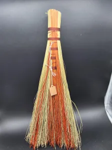 the backside of the broom shows more of the orange broom corn