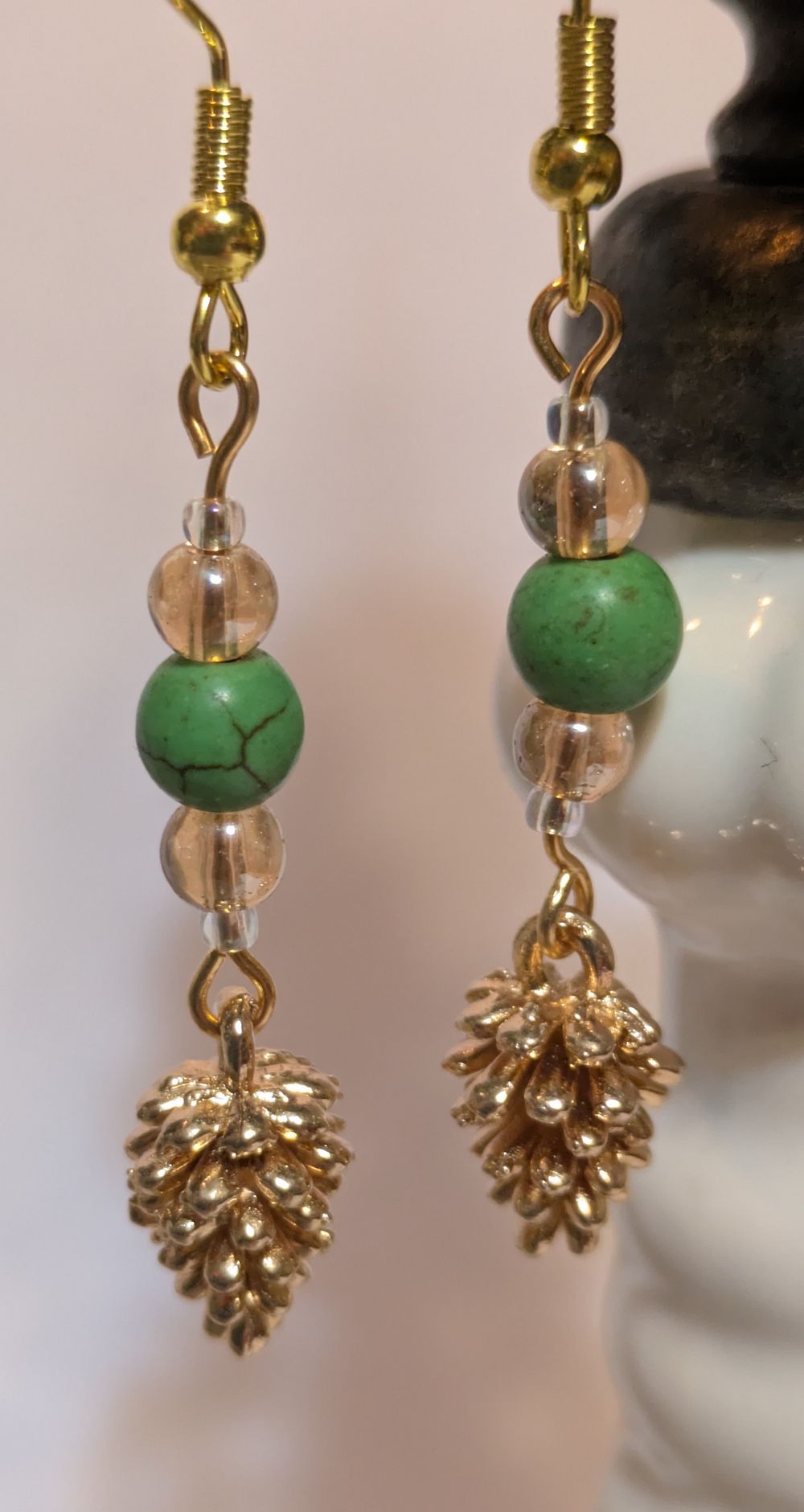 Copper pinecone dangling earrings; green bead accents