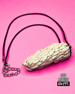 A side view of the sculpted necklace, each maggot is individually added one by one.