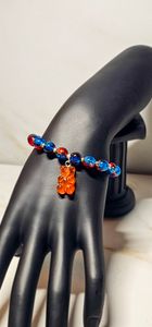 Red and blue beads paired with a gummy bear that compliments the bracelet.