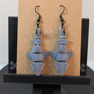 A view of the top of a pair of 3D printed great white shark earrings. This close, you can see the layer lines.