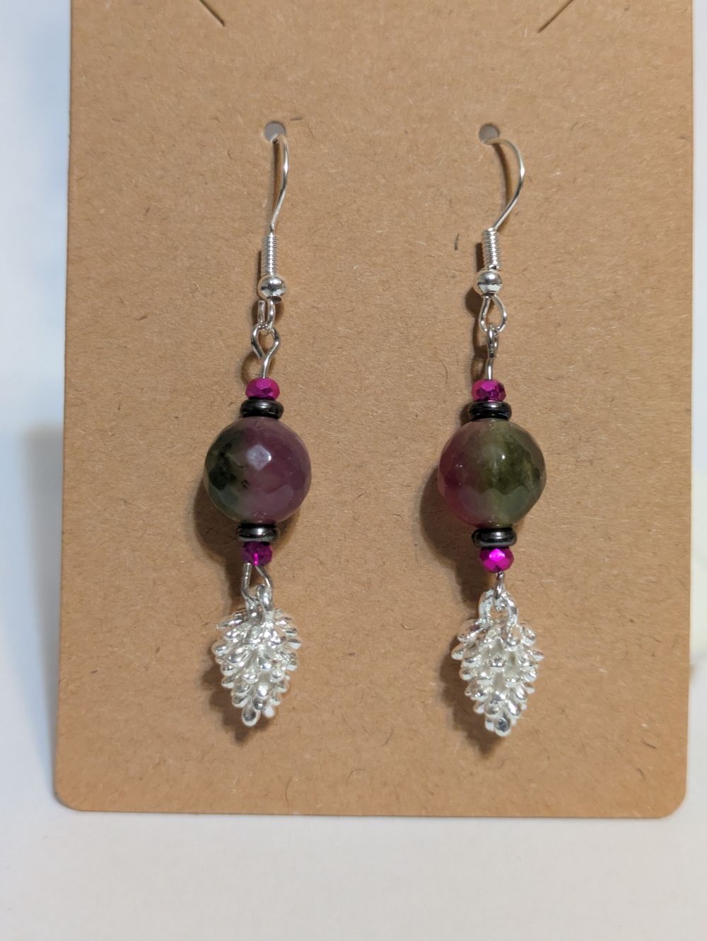 Silver pinecone dangling earrings; green/purple glass bead accents