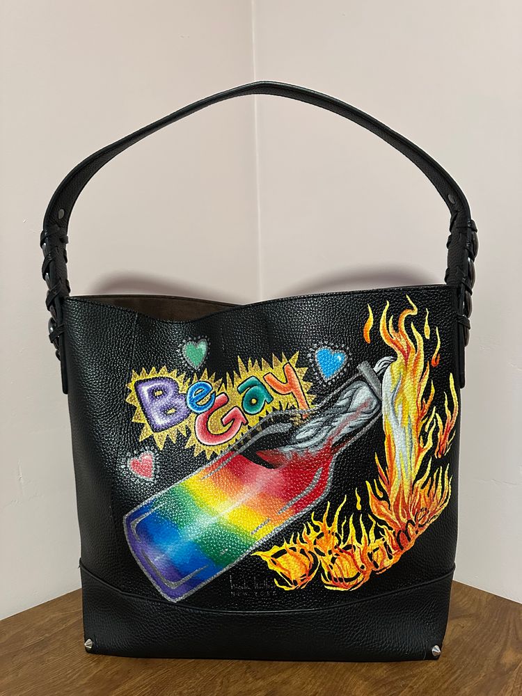 Hand painted pre-owned Nicole Miller black tote. Pro-LGBTQIA+ message with flaming rainbow Molotov cocktail and message “be gay, do crime!”