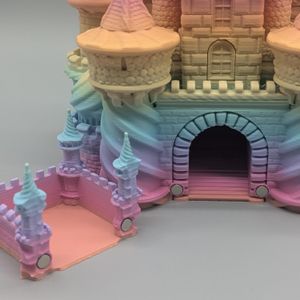 A close-up of the front of the dice tower. It shows the "catch" tray separated from the front of the castle, and it shows the magnets that keep it together.