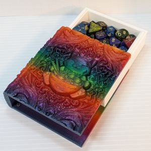 The happy cat ramen dice tome, with the "pages" slid out the top, showing a tray filled with dice.