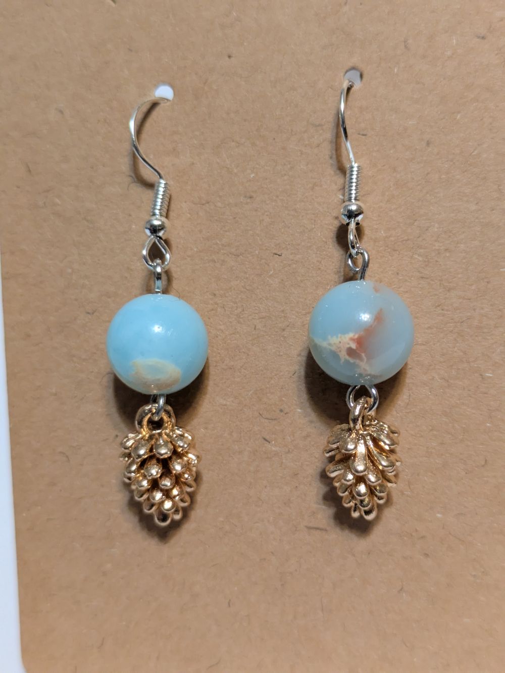 Copper pinecone dangling earrings; blue glass bead accents