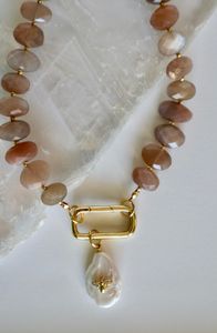 Closer look at the faceted peach moonstone beads, gold carabiner clasp, and removable pearl & bee charm.