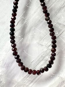 The deep red color of the micro faceted garnet beads on the Brenna Necklace