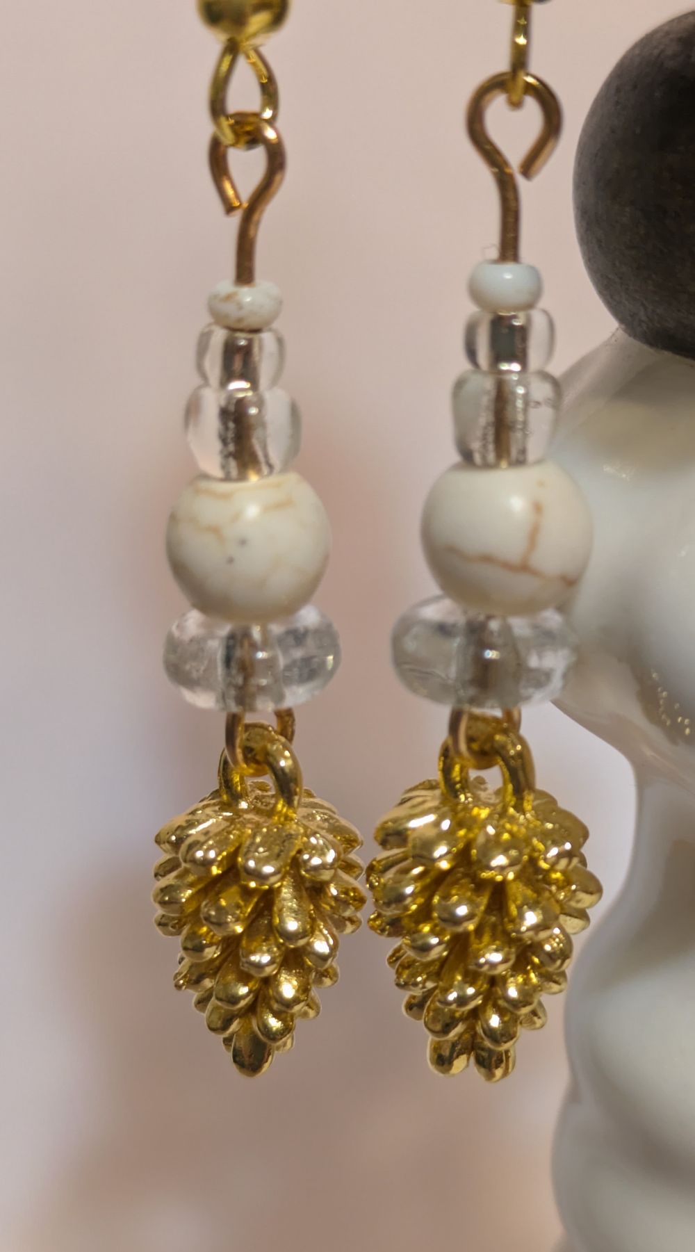 Golden pinecone dangling earrings; vintage white stone bead accents