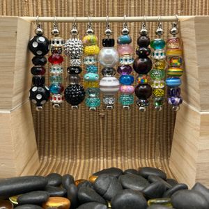 Left to Right in Order: Dice Ball, Blue and Red, Black and Silver, Yellow and Baby Blue, White and Black, Cool Pastels, Wood and Rainbow, Green and Yellow, Rainbow (Single)