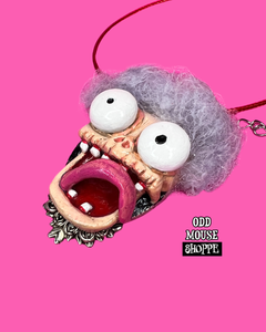 A 3/4 view from the right side of the sculpted pendant