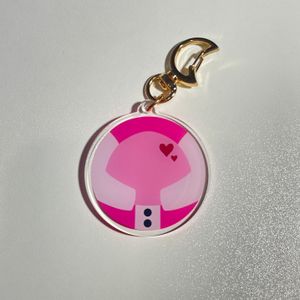 pink keychain with gold clasp on white tabletop