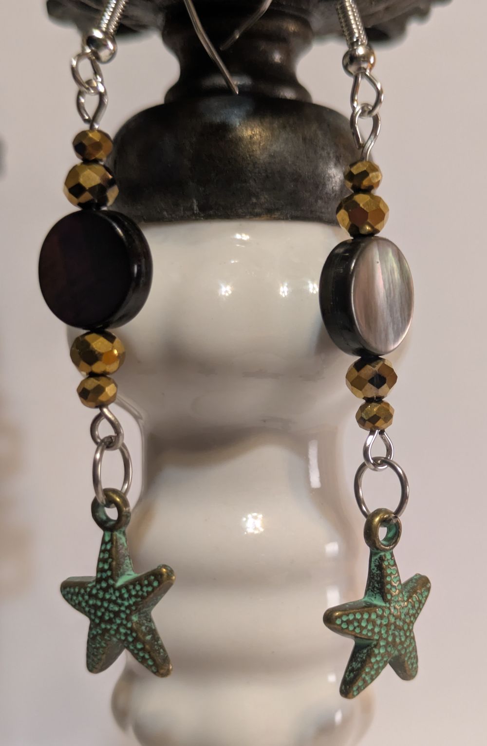Starfish charmed earrings with patina and abalone shell bead accent