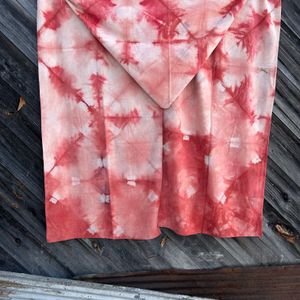 Red Madder Feather scarf hanging on a wall 