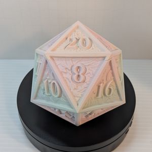 The 3D printed d20 dice tower, resting with the 8 in front and the removable 20 above it. This shows the gradient from a light pink to a light blue and back a little clearer.