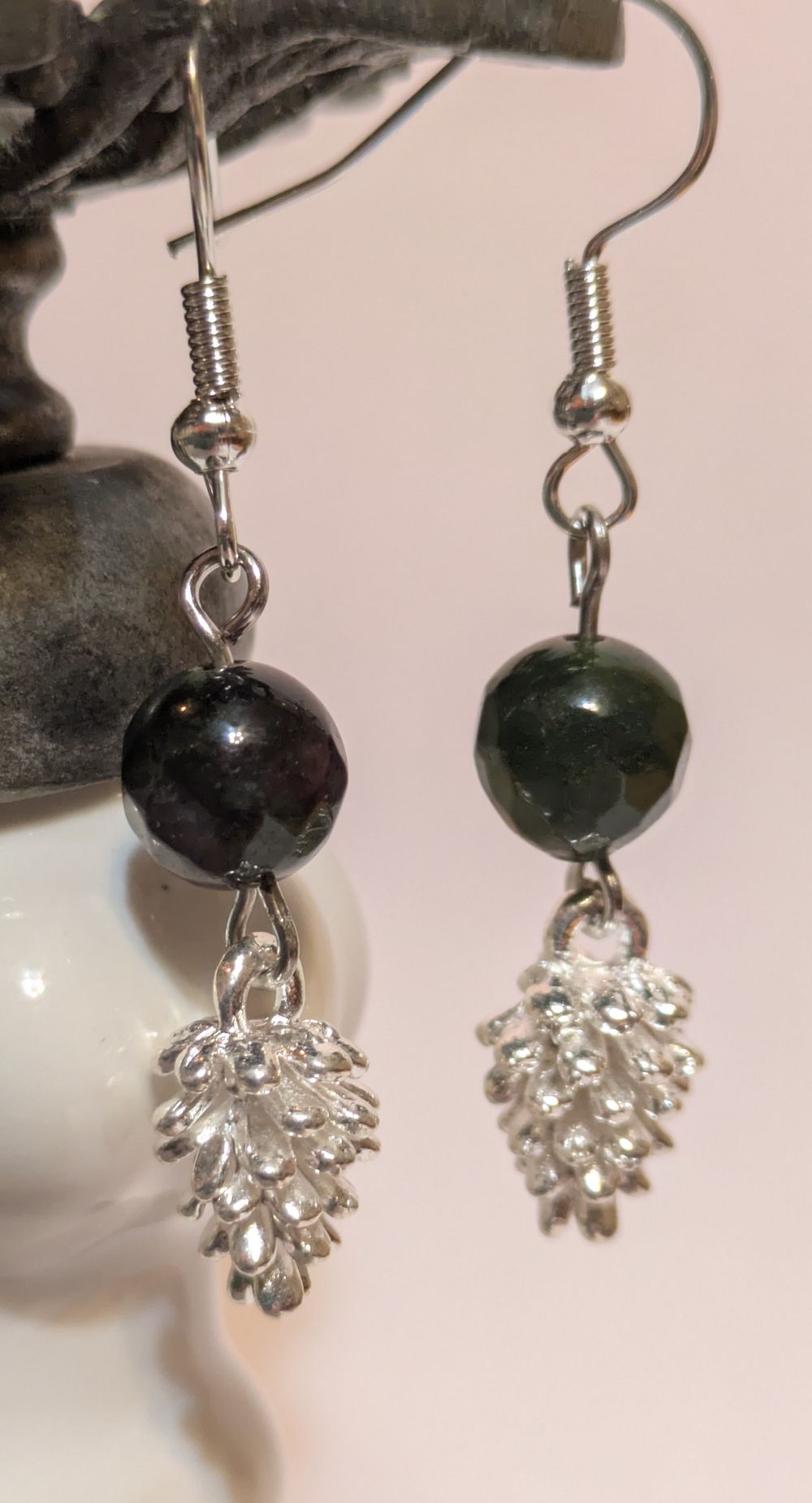 Silver pinecone earrings with deep green/purple stone accent beads