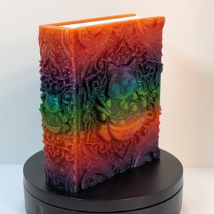 An angled shot of the happy ramen cat tome, showing the spine, which has similar artwork to the front.